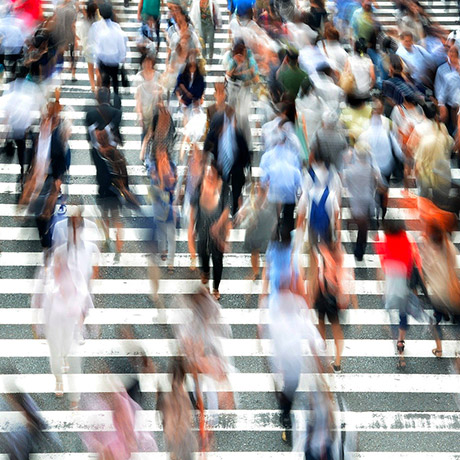 Blurry image of pedestrians crossing the road