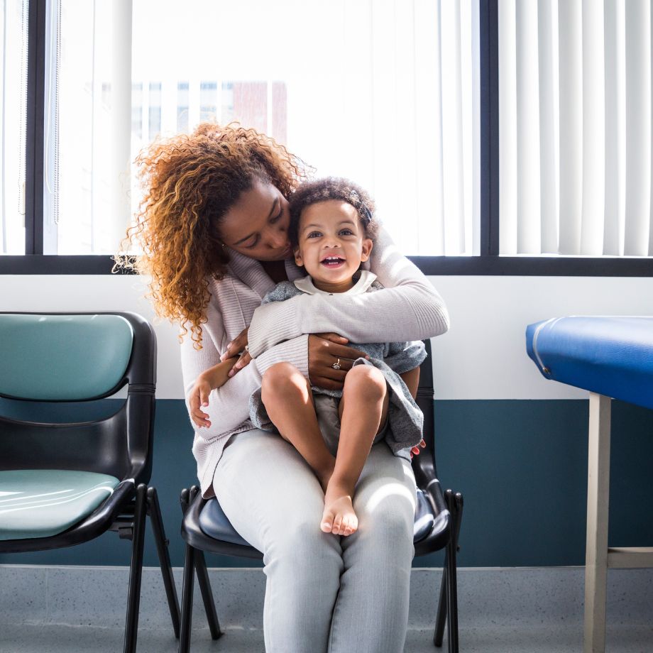 Parent holding a toddler on her lap